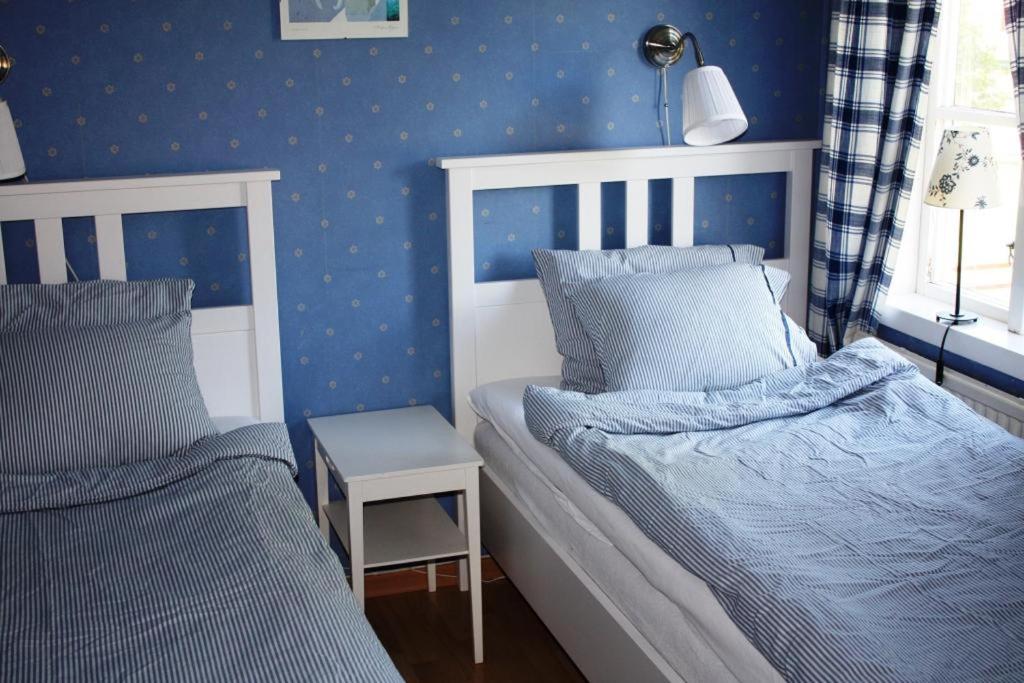 Кровать или кровати в номере Jaktlyckan, Tuna Gård