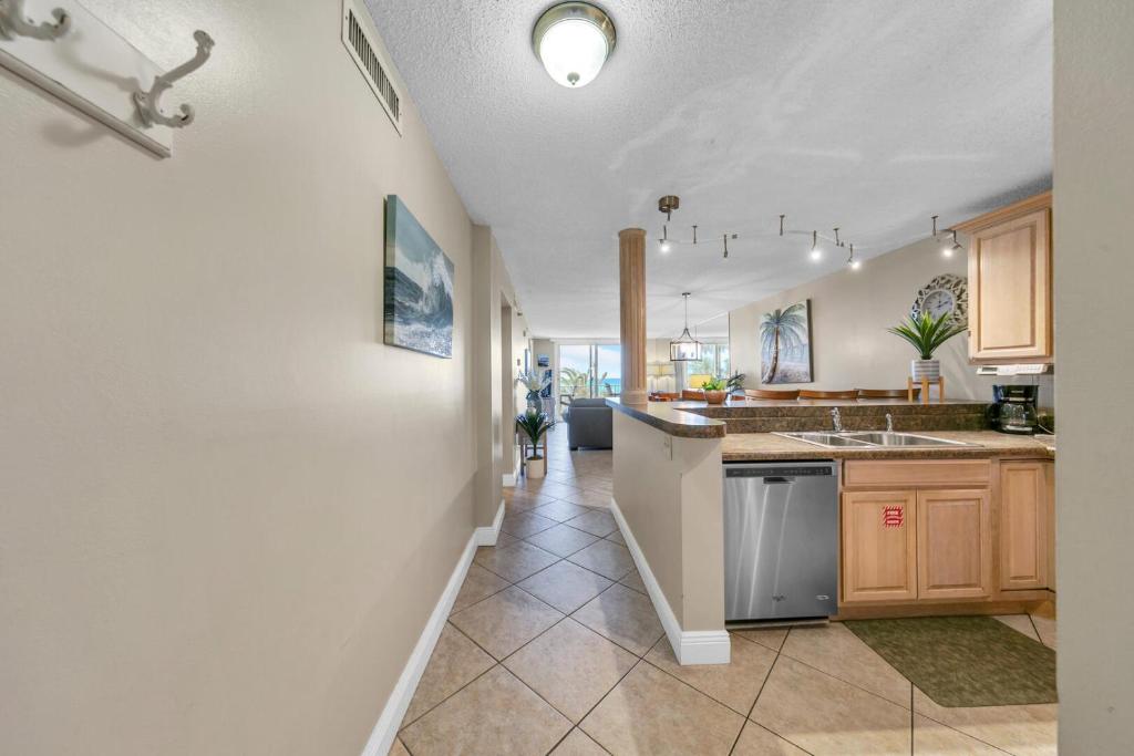 a kitchen with a sink and a counter at Destin on the Gulf 205 - Updated Gulf Front Property with Free Beach Service in Destin