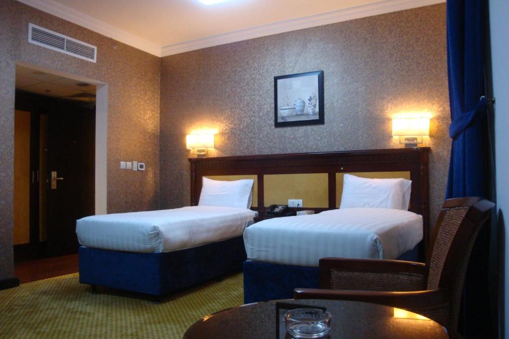 Tempat tidur dalam kamar di Alolayan Plaza Hotel