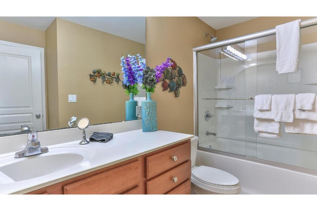 ein Badezimmer mit Waschbecken, Toilette und Dusche in der Unterkunft Beach Resort 507 - Great Views Beautiful Decor Zero Entry Pool in Destin