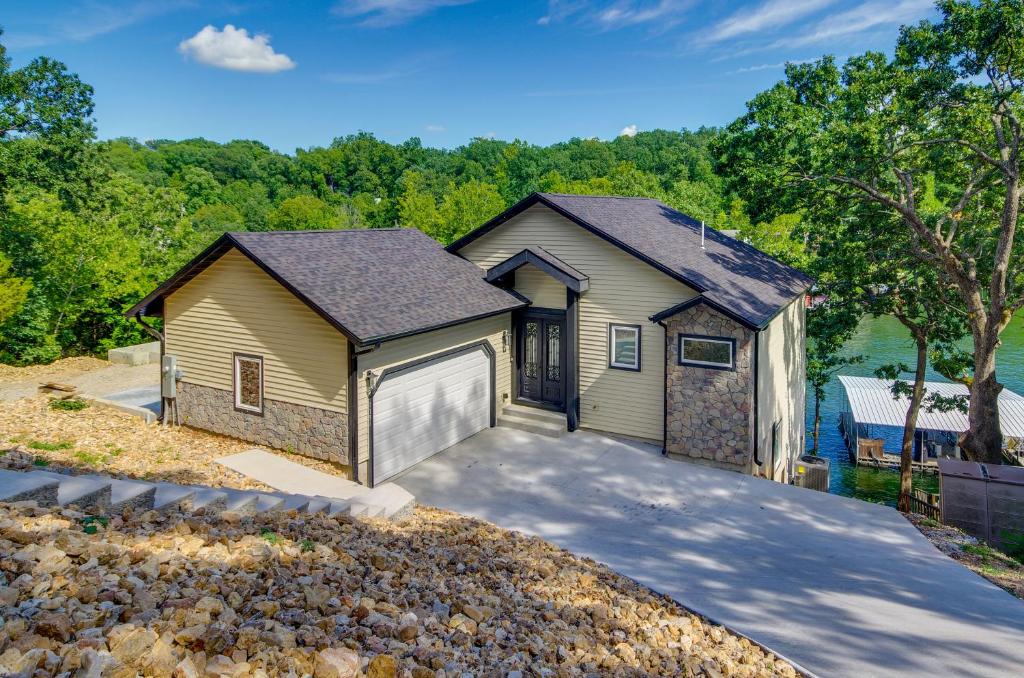 a house with a garage and a driveway at Lakefront Osage Beach Retreat Floating Swim Dock! in Osage Beach