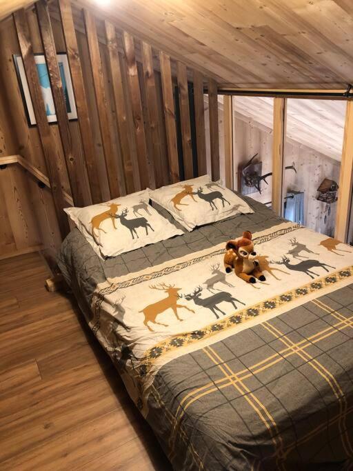 a bedroom with a bed with deer pillows at Chalet au pied des pistes du Cambre d Aze in Saint-Pierre-dels-Forcats