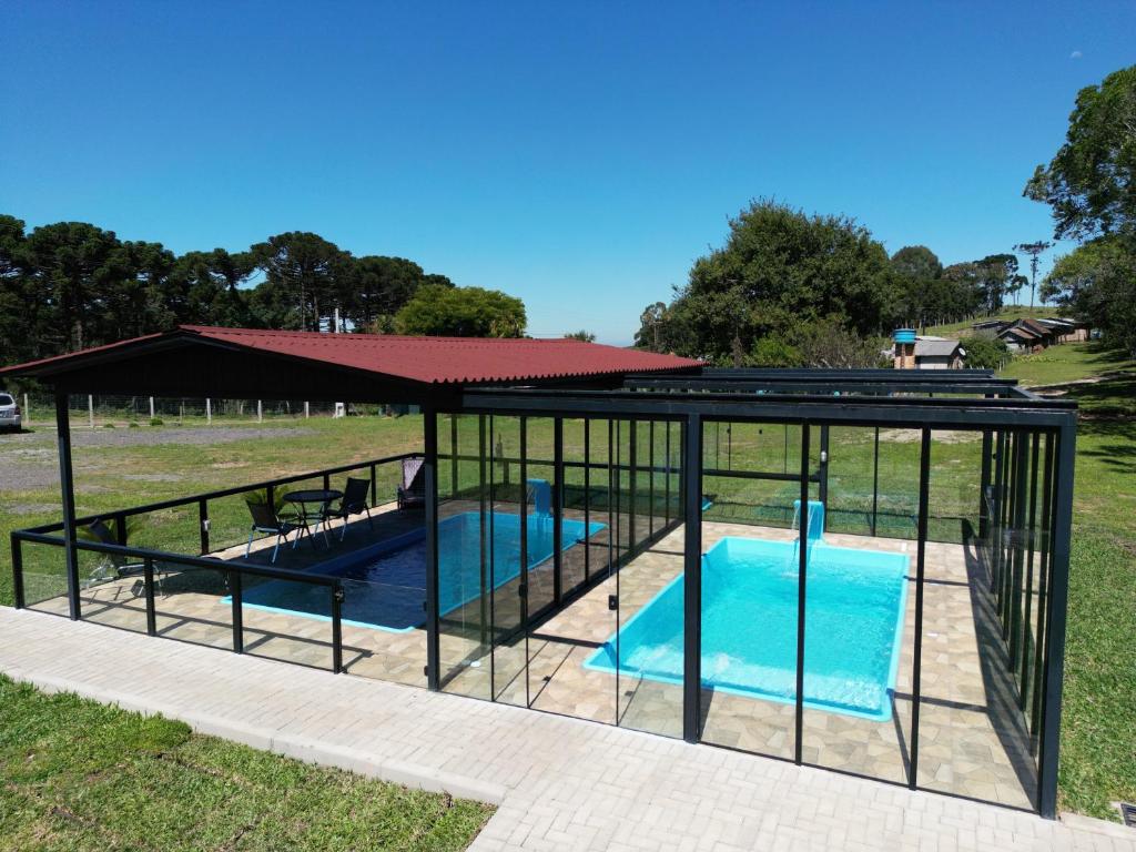 a pavilion with a pool in a park at Reserva Guimarães in Cambara do Sul