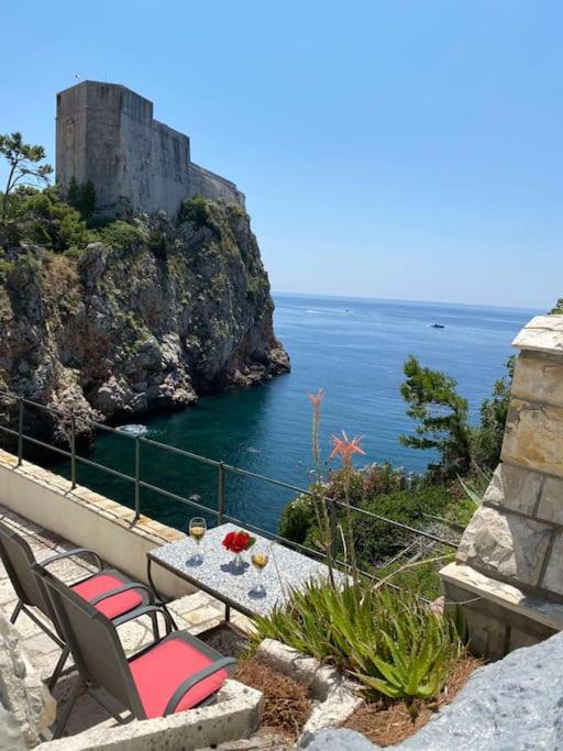 a table and chairs with a view of the ocean at Villa Kolorina in Dubrovnik