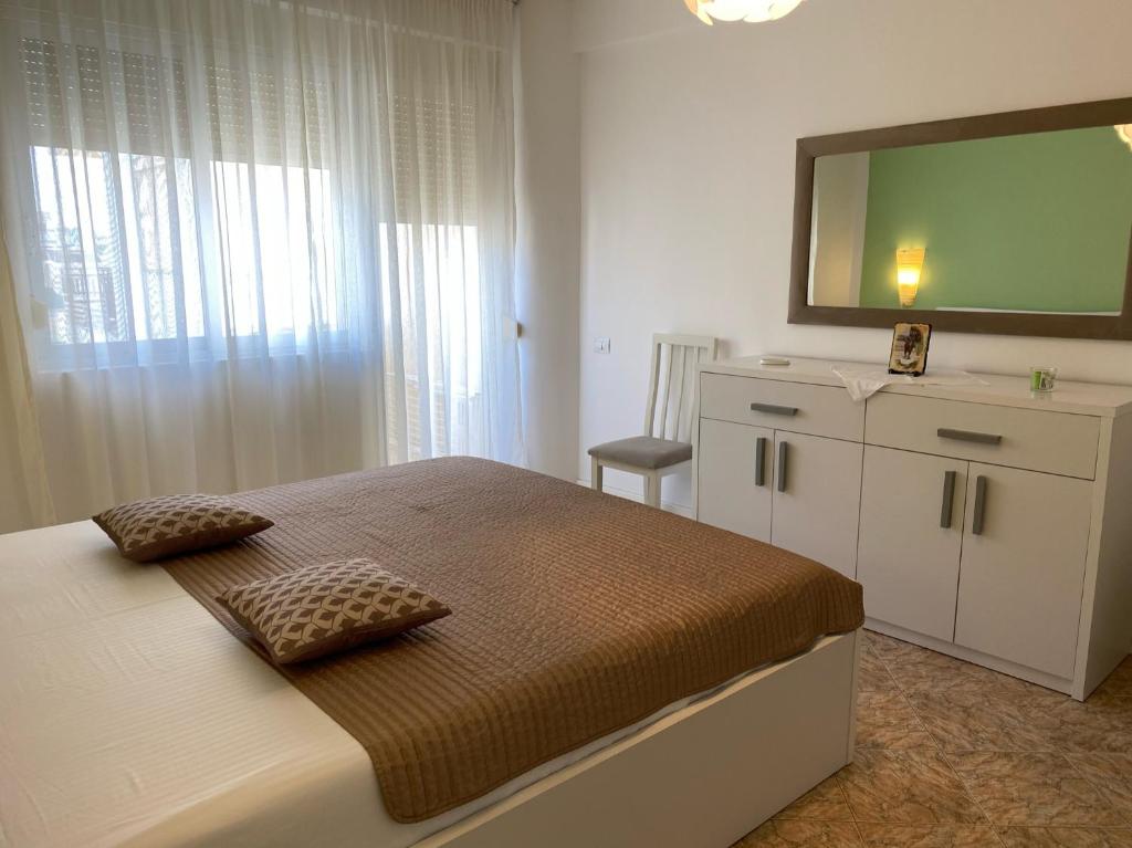 a bedroom with a bed with a television on top at Adelina's Delux Apartament Durres in Durrës