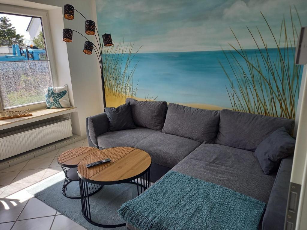 a living room with a couch and a table at Ferienhaus Eckernfeld Bremerhaven in Bremerhaven