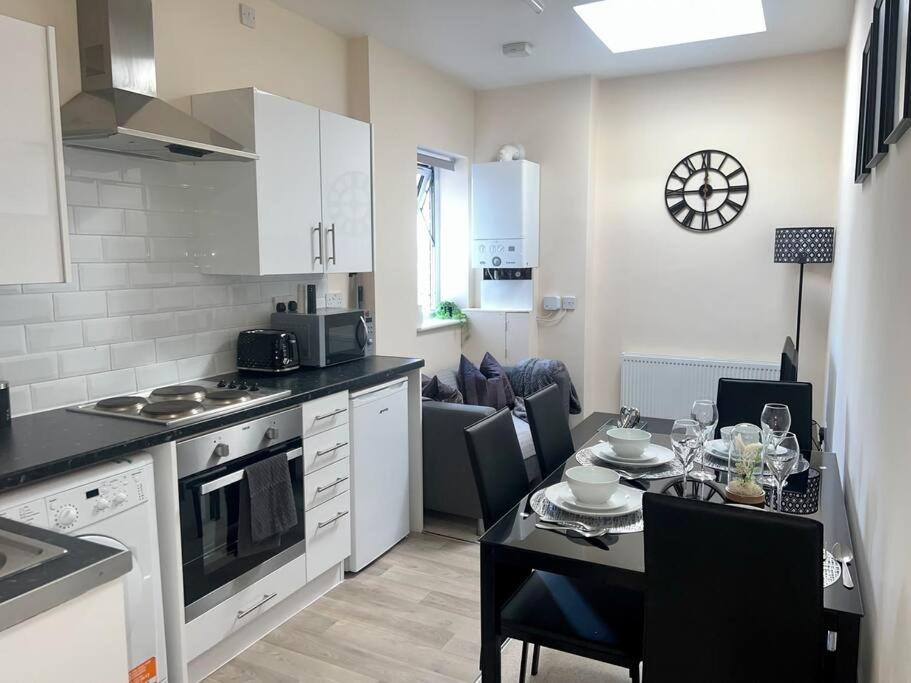 a kitchen with a table and a dining room at 2 Bedroom Apartment with Balcony in Oxford