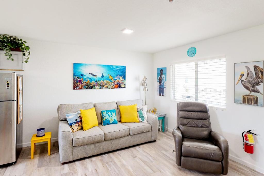 a living room with a couch and a chair at Ocean Isles #119 in Marathon