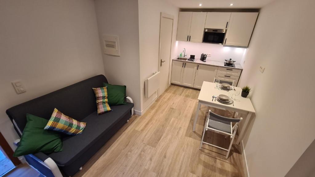 a living room with a couch and a small table at Les Bossons Studio in Chamonix