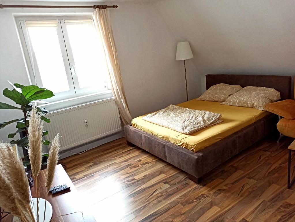 a bedroom with a bed and a large window at Wohnung nah zur Uniklinik in Würzburg