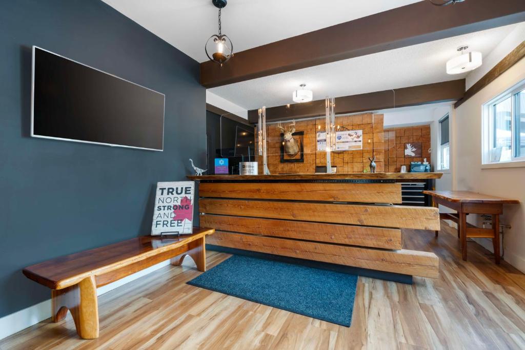 a restaurant with a bench and a bar at Stoke Hotel SureStay Collection by Best Western in Revelstoke