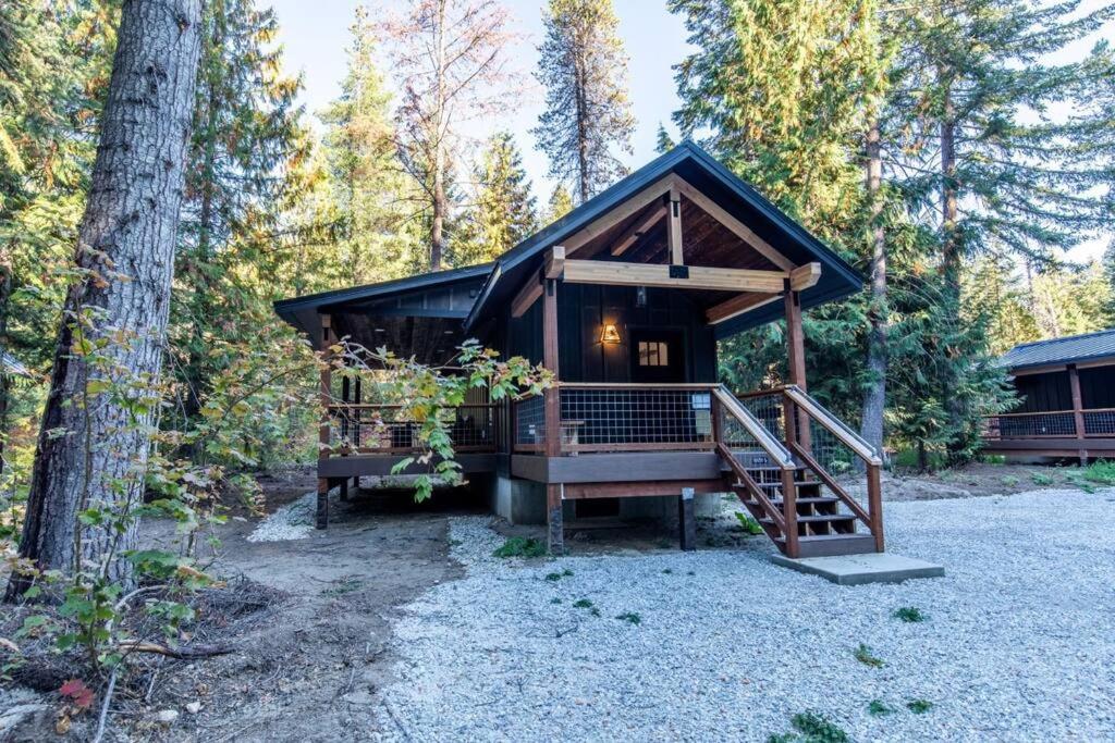 a cabin in the woods with a staircase leading up to it at Tall Pines a cozy 1 bedroom Tiny Cabin in Leavenworth