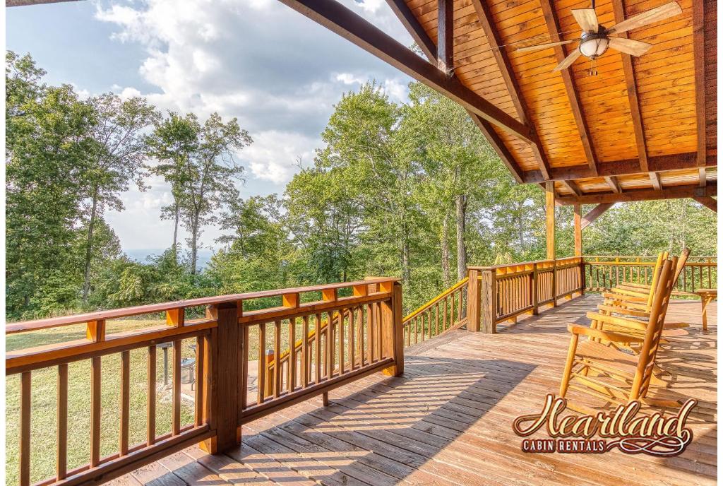 a large deck with chairs and a roof at Halfway To Heaven in Sevierville