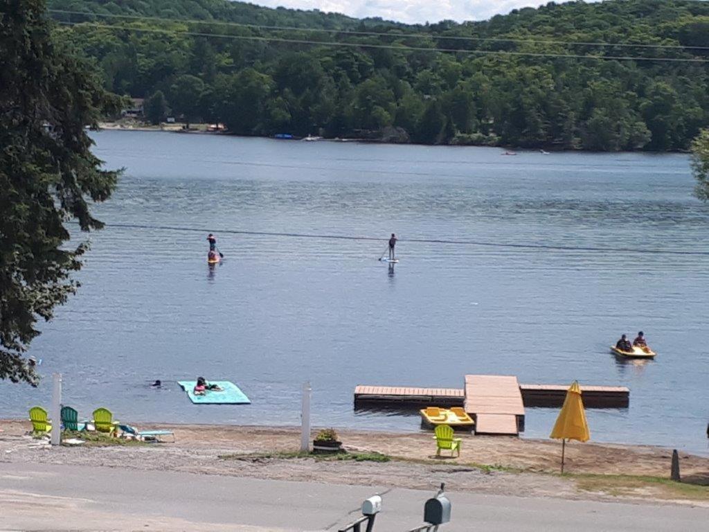 a group of people swimming in a lake at GetAways At Haliburton Heights in Haliburton