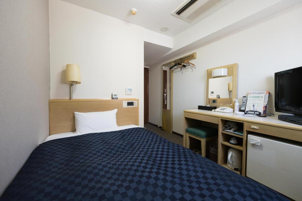 Postel nebo postele na pokoji v ubytování Matsue Urban Hotel
