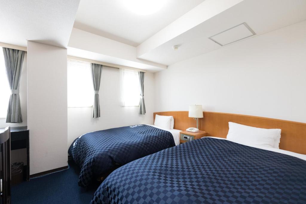 Postel nebo postele na pokoji v ubytování Matsue Urban Hotel