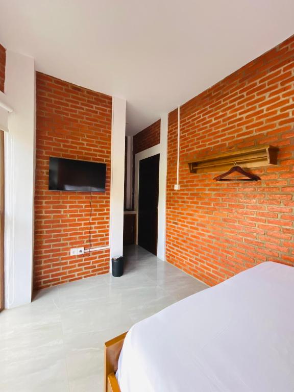 Postel nebo postele na pokoji v ubytování Puu Pau Hotel & Coffee Shop
