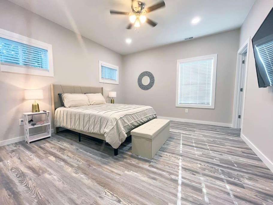 a bedroom with a bed and a ceiling fan at Cozy New Build Entire Home - 5 Star Getaway in South Euclid