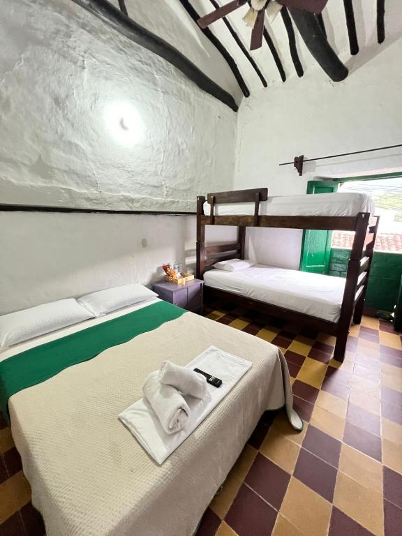 Postel nebo postele na pokoji v ubytování Green Door San Gil