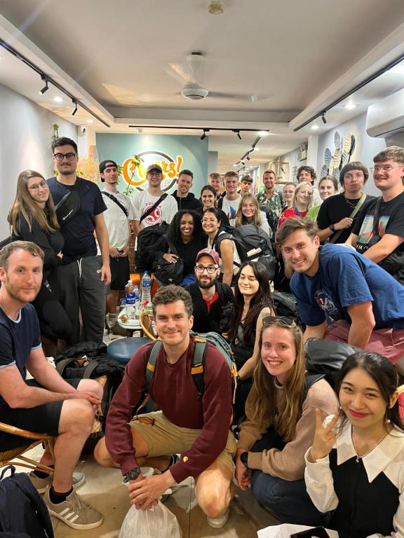 a group of people posing for a picture in a room at Cheers Hostel Hanoi in Hanoi