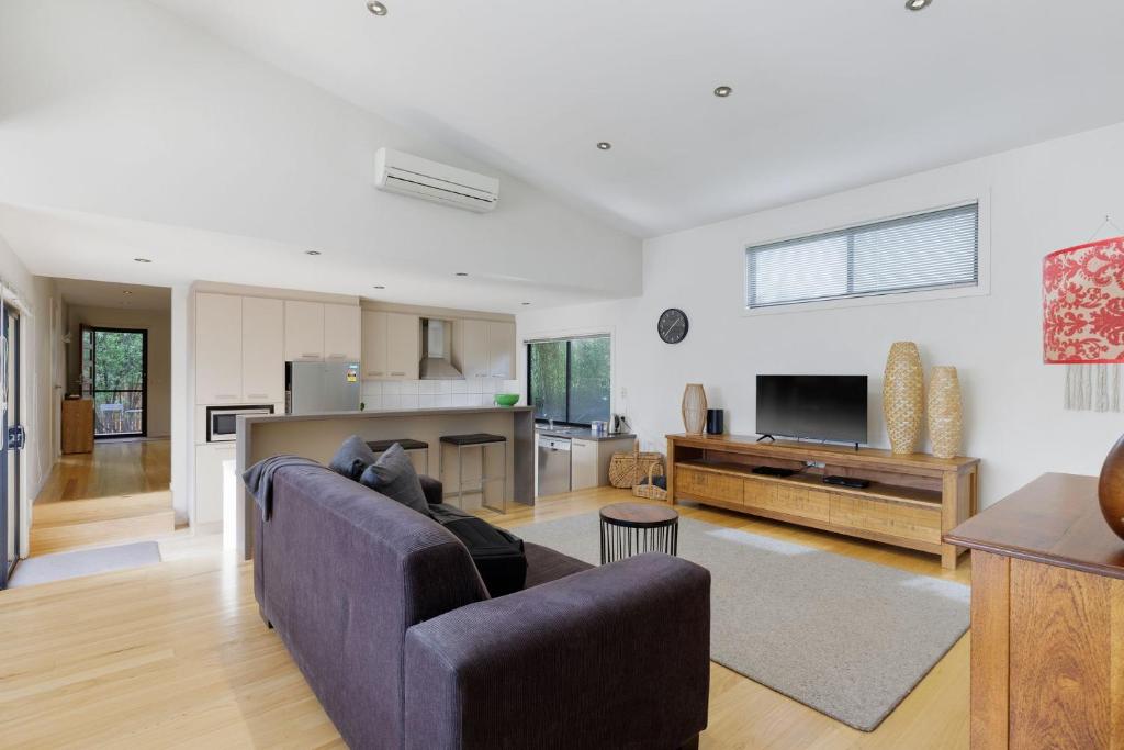 a living room with a couch and a kitchen at Woolamai Breeze in Cape Woolamai
