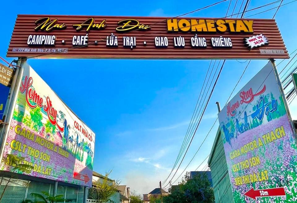 a sign for a restaurant in a city at Homestay Mai Anh Đào in Da Thien