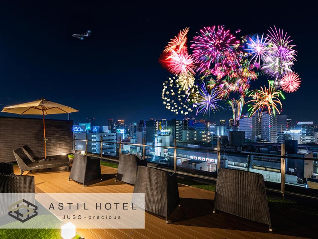 a view of fireworks from an asahi hotel at night at Astil Hotel Juso Precious in Osaka