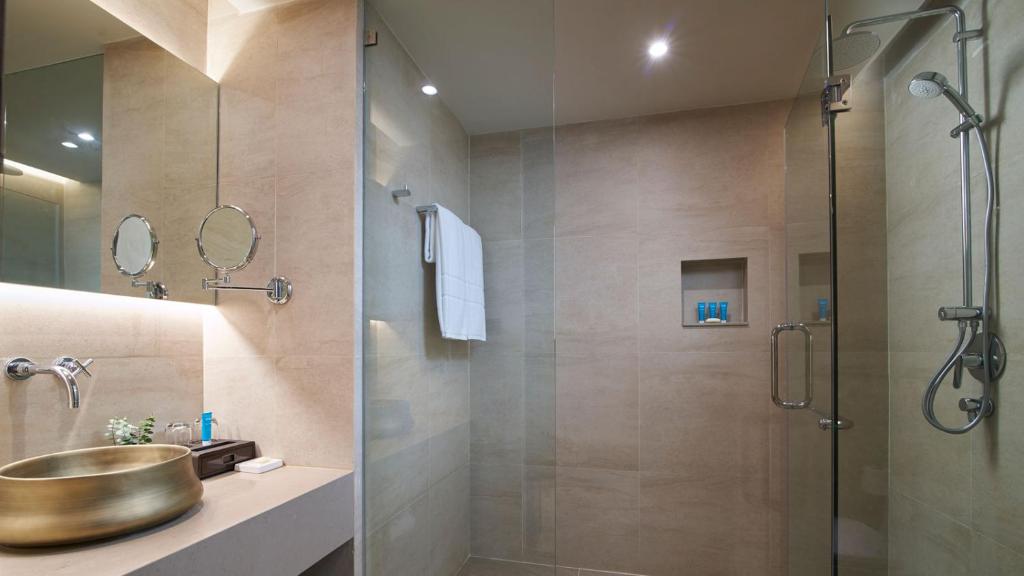 a bathroom with a sink and a shower at Amari Vogue Krabi in Tab Kaek Beach