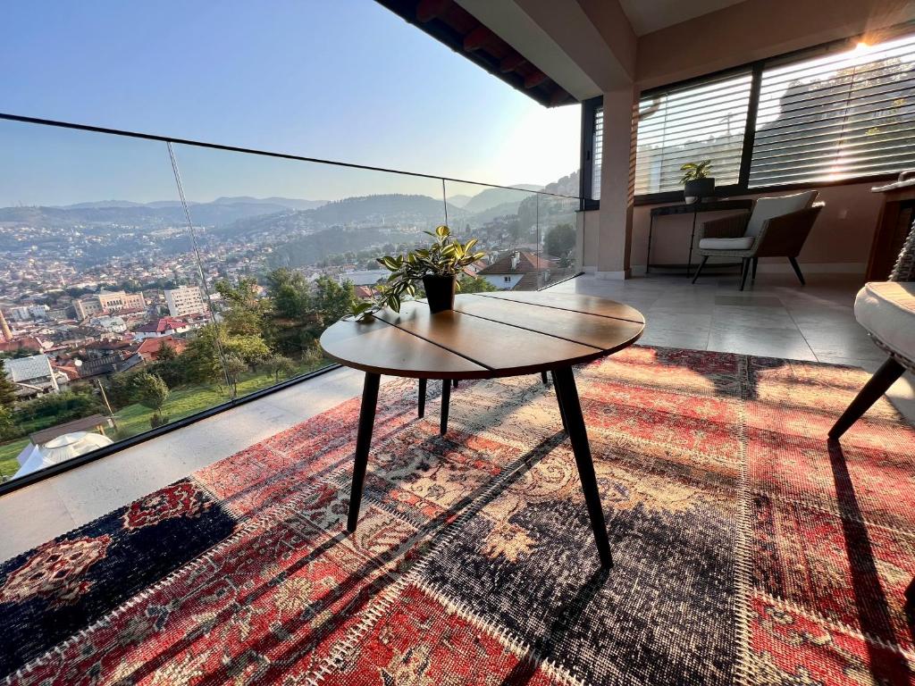 a room with a table and a view of a city at Penthouse Sarajevo in Sarajevo