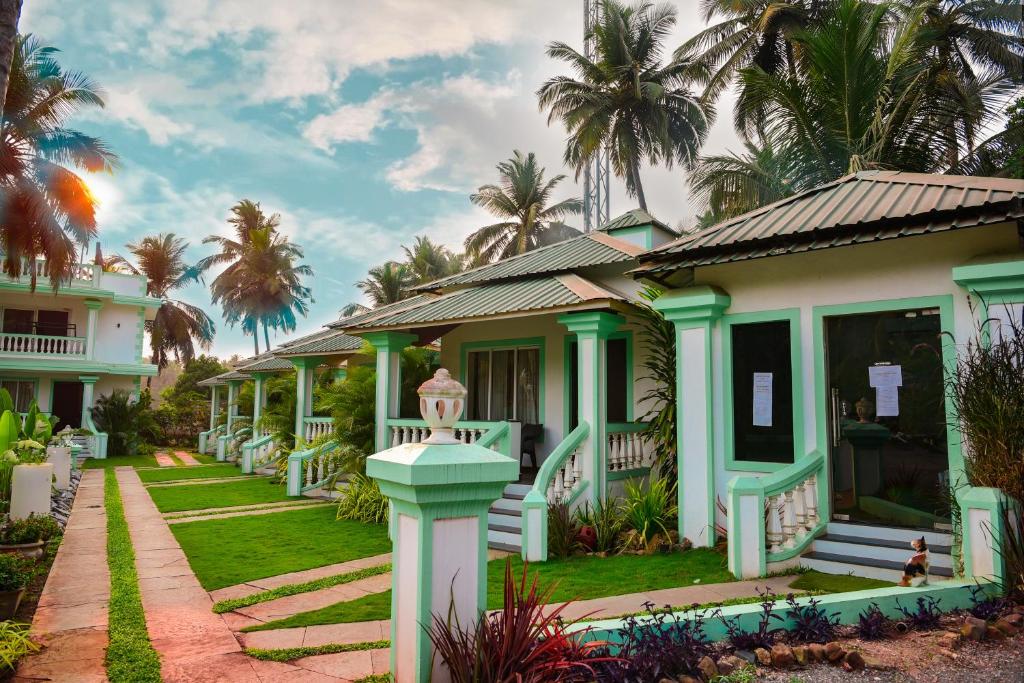 a row of houses with palm trees in the background at D7 La Serene in Benaulim