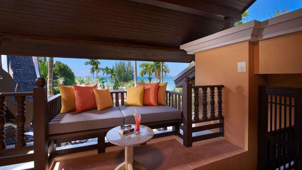 a porch with a couch and a table at Amari Vogue Krabi in Tab Kaek Beach