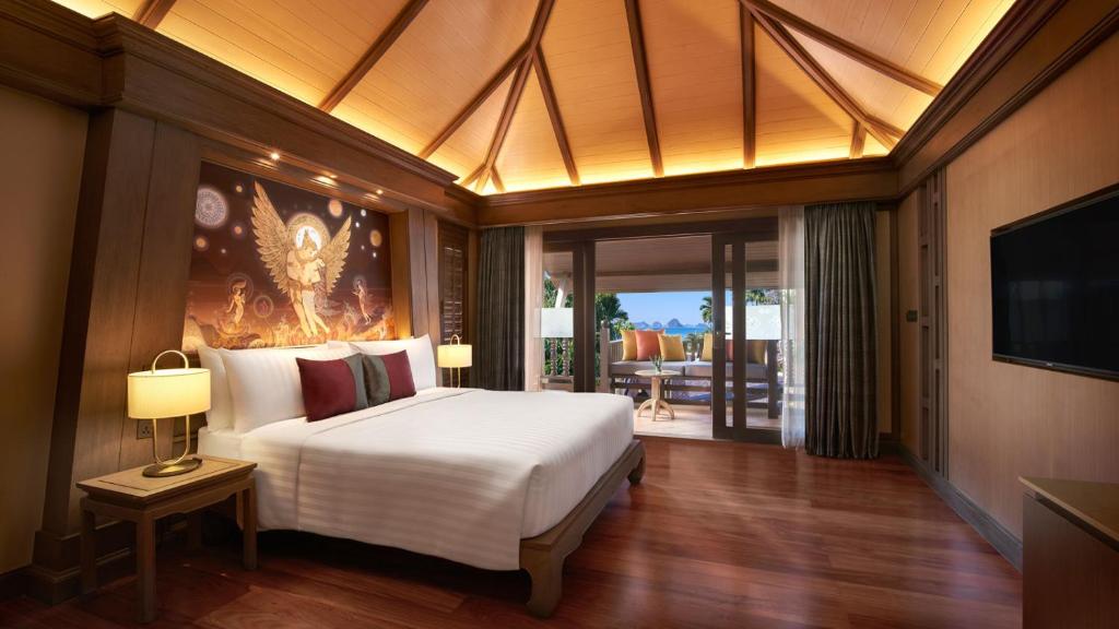 a bedroom with a large white bed and a television at Amari Vogue Krabi in Tab Kaek Beach