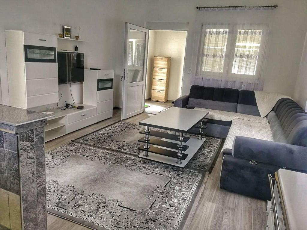 a living room with a couch and a table at Apartman Visoko-Oaza mira in Visoko