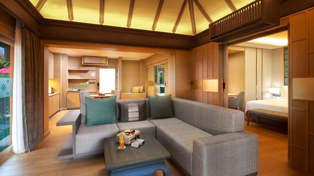 a living room with a couch and a bed at Amari Vogue Krabi in Tab Kaek Beach