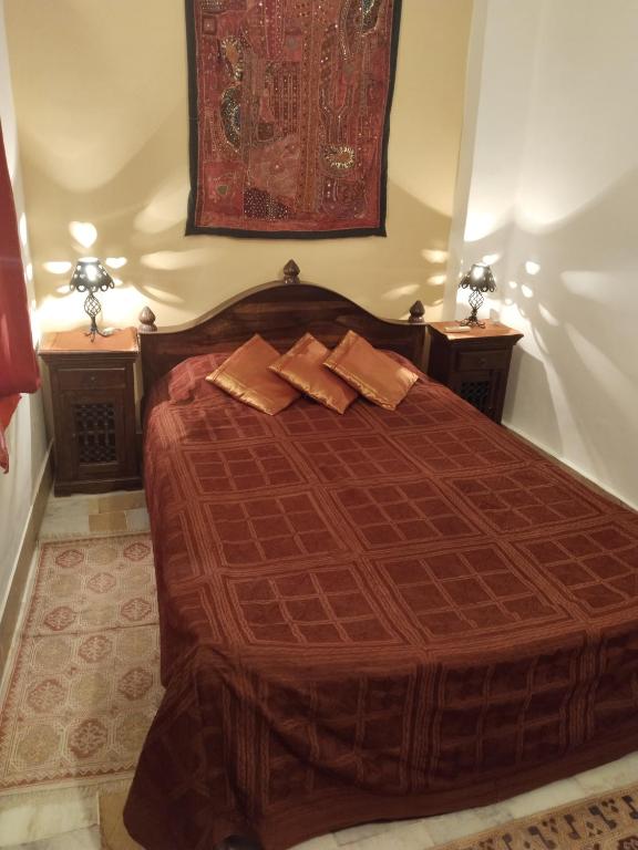 a bedroom with a bed with two night stands at Killa Bhawan Lodge in Jaisalmer