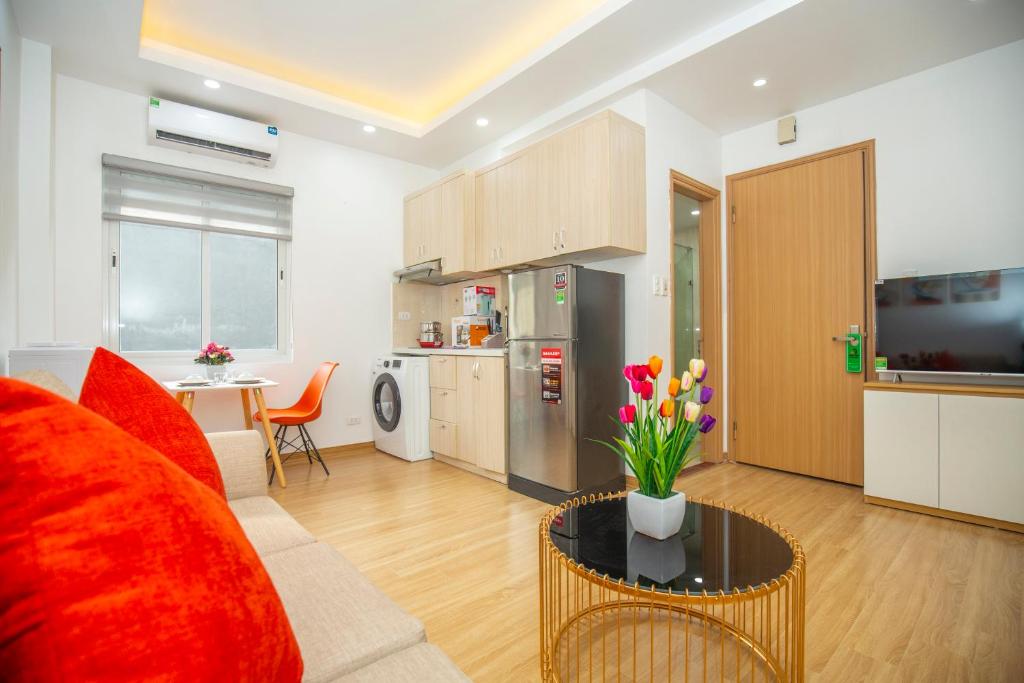 河內的住宿－Sumitomo11 Apartment 5-39 Linh Lang，客厅配有沙发和鲜花桌