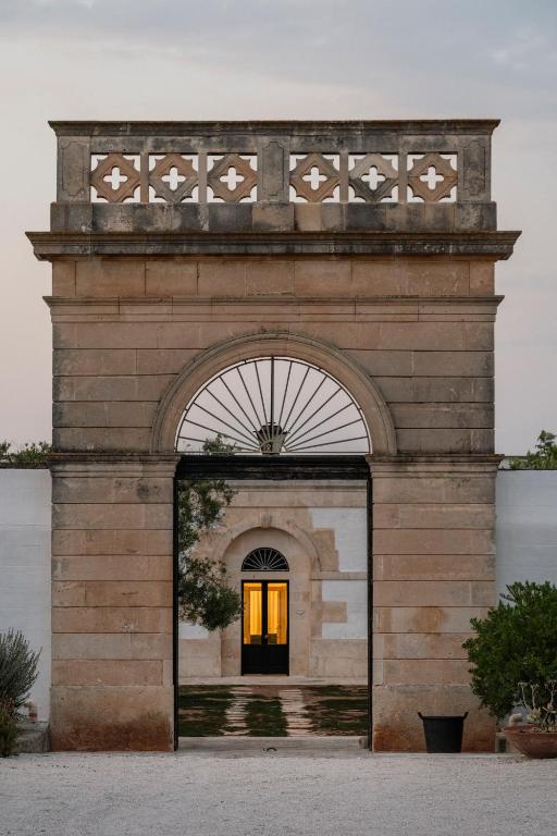 an entrance to a building with an archway at Masseria Gorgognolo in Ostuni