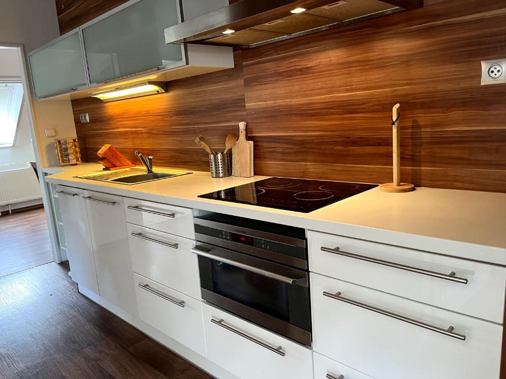 a kitchen with a stove and a sink at Apartmán Štěpán in Velké Karlovice