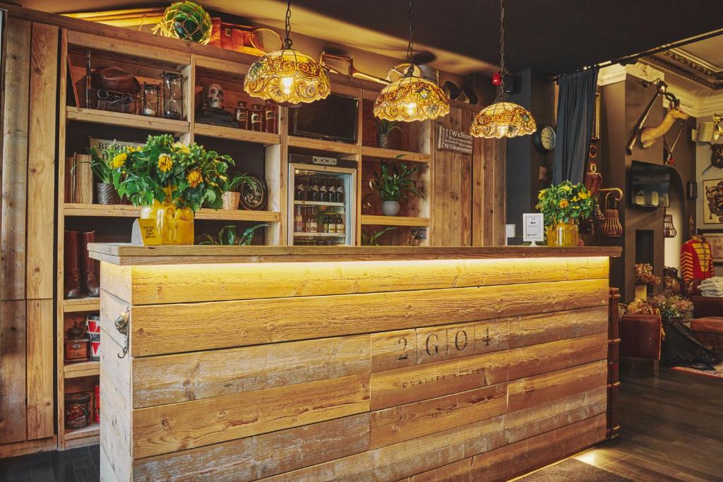 a bar with a wooden counter with flowers and lights at The Legacy by 2GO4 City Center in Brussels