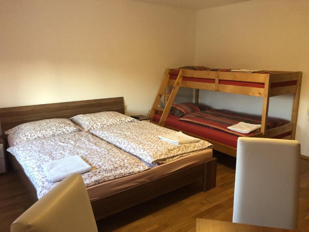 a bedroom with a bed and two bunk beds at Prenočišča Kovač in Beltinci
