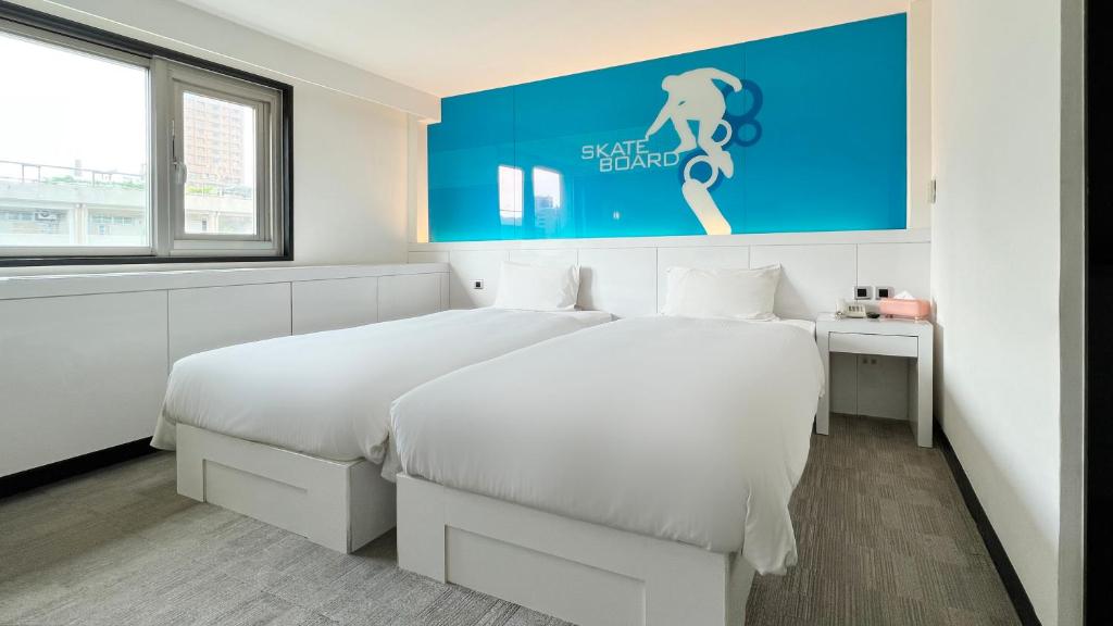 Postel nebo postele na pokoji v ubytování Guide Hotel Kaohsiung Liuhe
