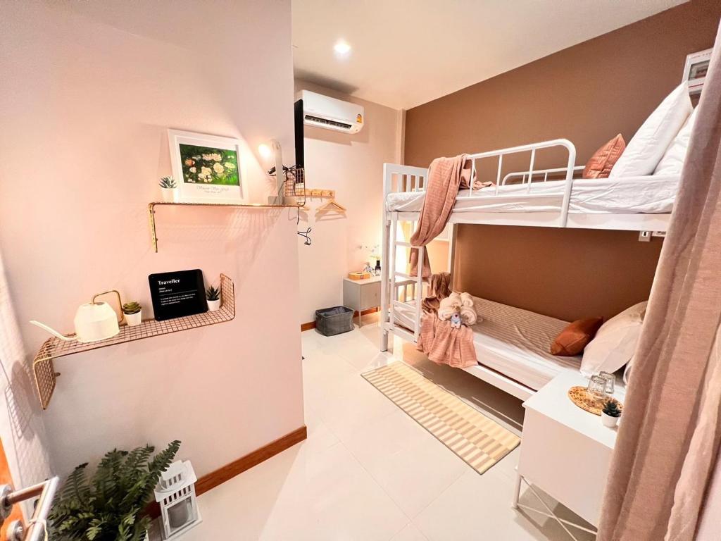 a room with two bunk beds and a hallway at Por poshtel Kanchanaburi in Kanchanaburi City