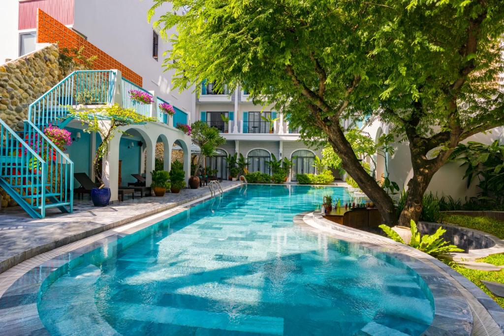 a swimming pool in front of a building at Salmalia Boutique Hotel & Spa in Da Nang