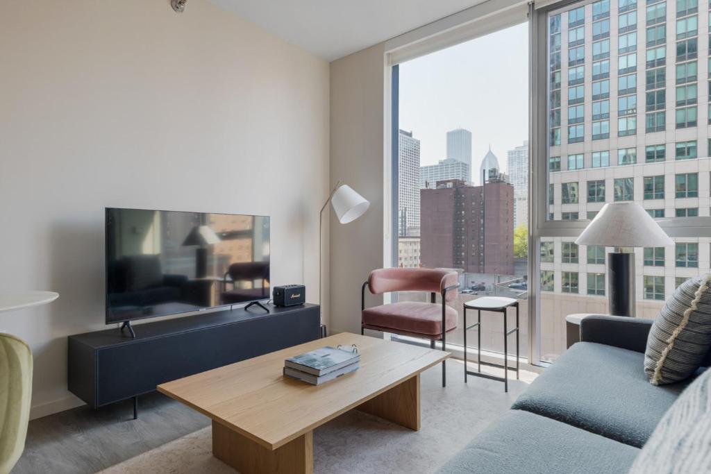 a living room with a couch and a large window at River North jr 1br w game room nr beach L CHI-971 in Chicago