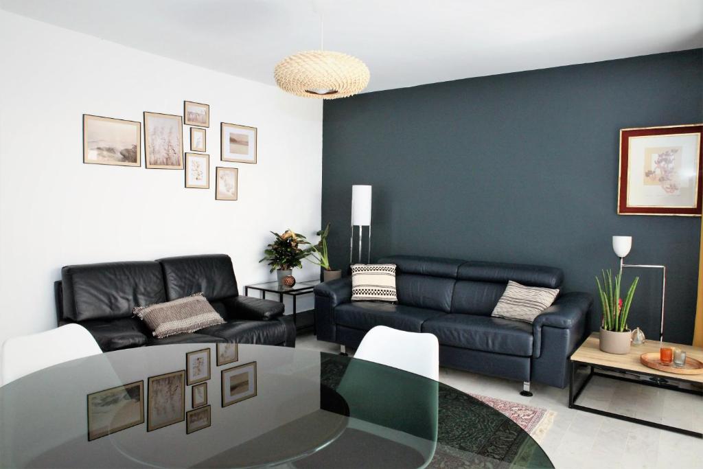 a living room with a couch and a table at Appartement T3 plein centre in Saint-Raphaël