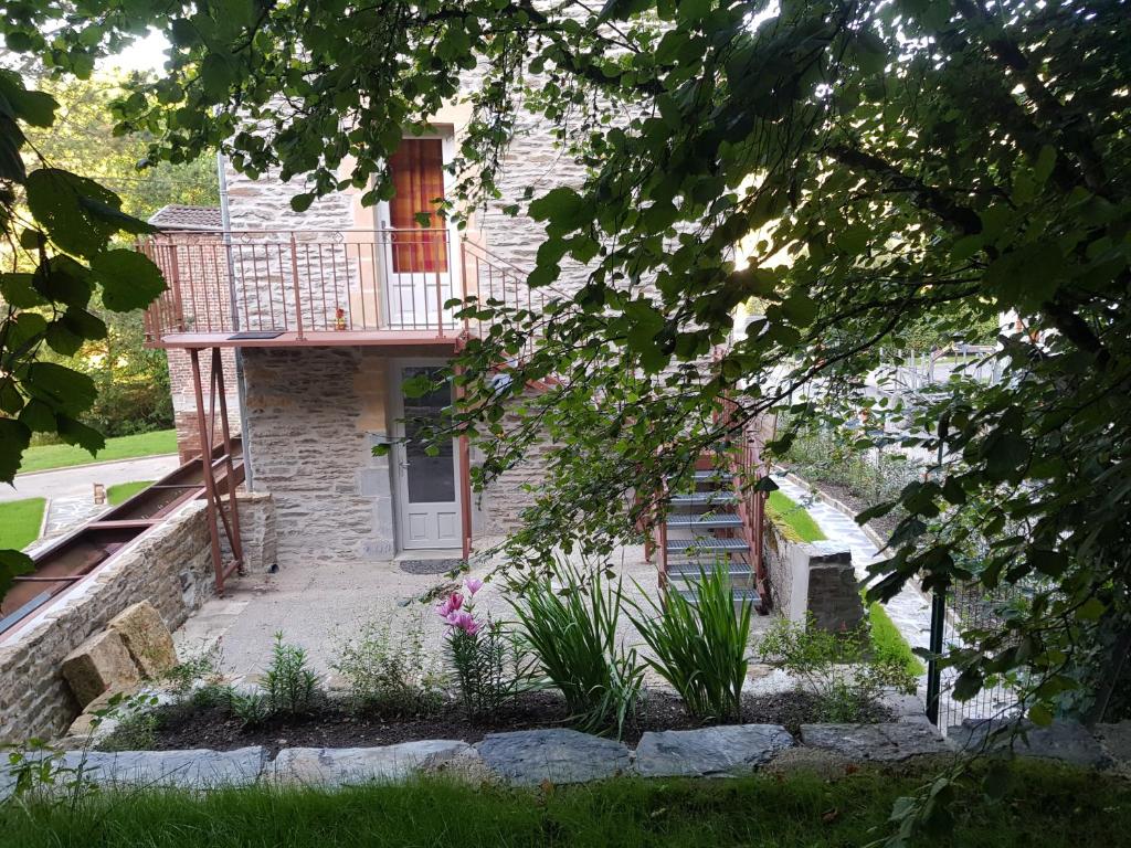 a brick house with a porch and a balcony at Le moulin de la Chaîrâ 