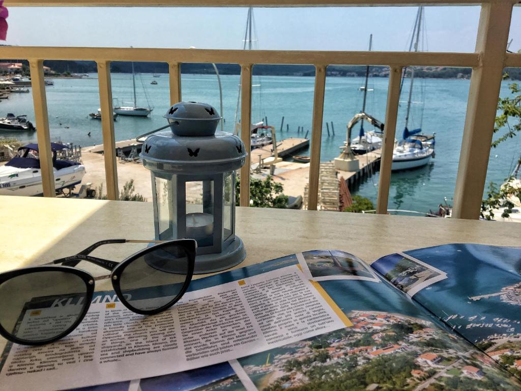 a pair of glasses sitting on a table with a book at Apartment Anima 3 in Klimno