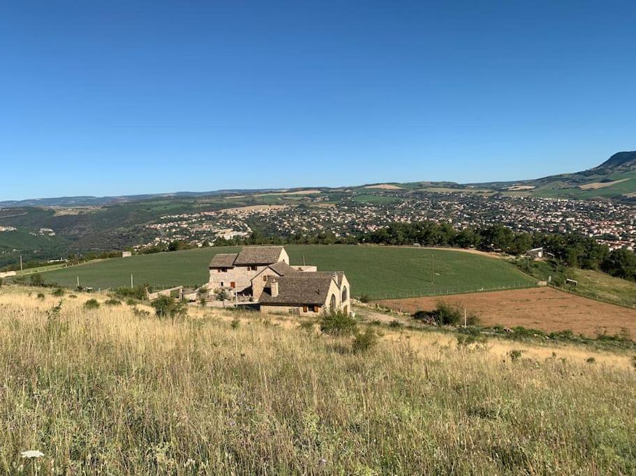 an old house in the middle of a field at Domaine des Combes - La Ferme aux Anes 14 pers. in Millau