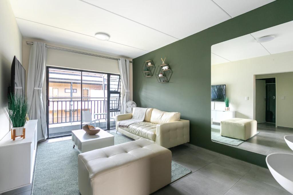 a living room with a couch and a table at Modern 2 bed apartment, Secure estate in Midrand