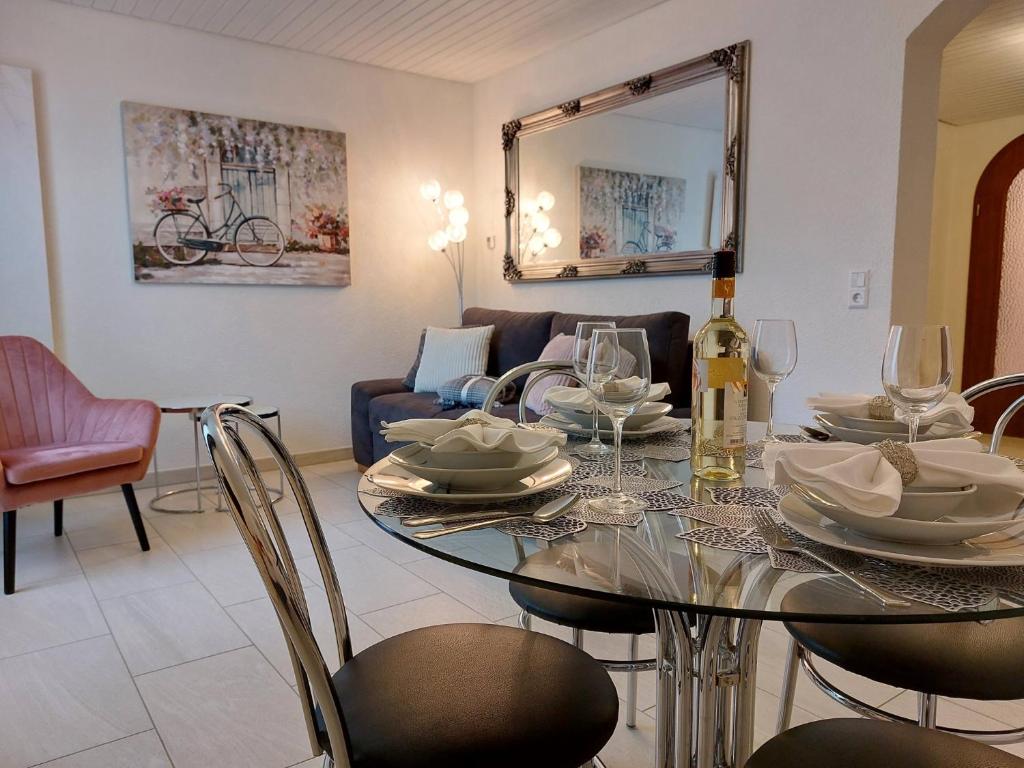 a dining room with a glass table and chairs at Pension Waldblick in Heidenheim an der Brenz